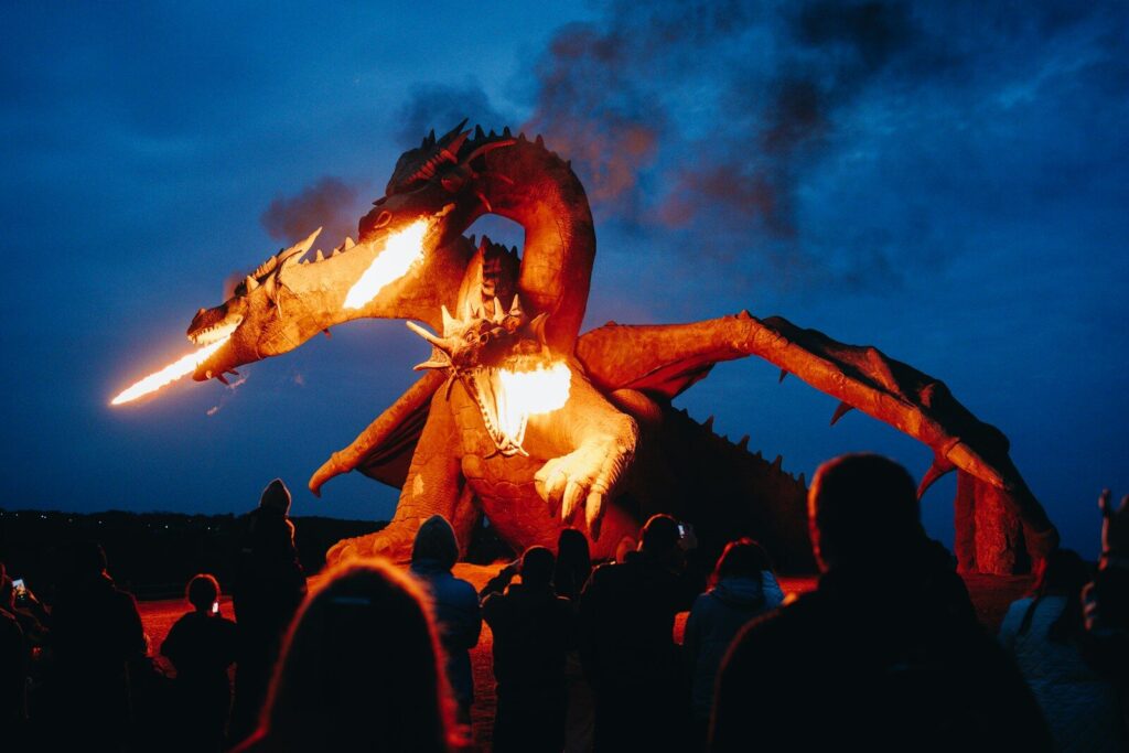 Dragon effigy breathes fire over a crowd at night, It's hard to find an image of the conquest without copyright images